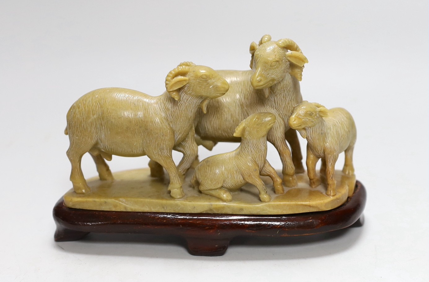 A Chinese carved soapstone ram and lamb group, on plinth, 11cms high